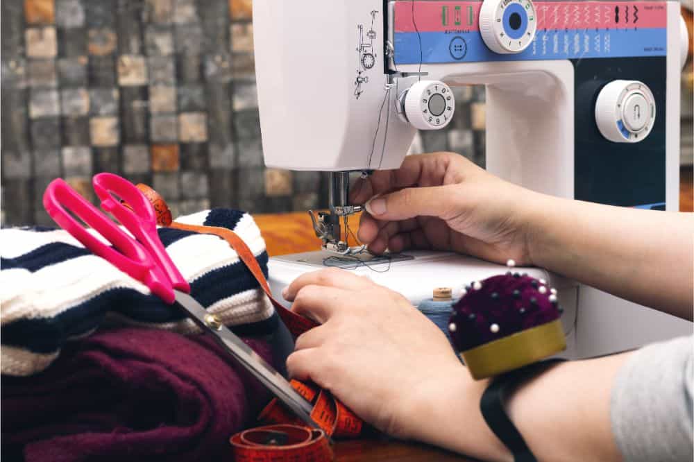closeup women sewing on a machine