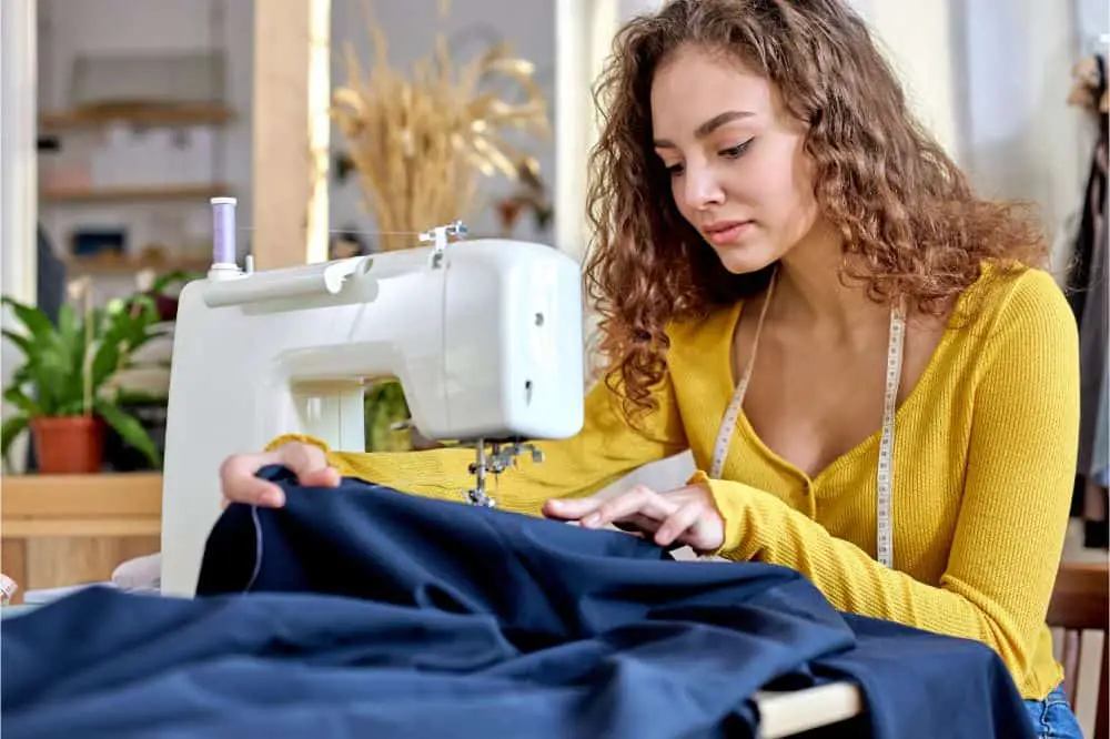 young tailor working on sewing machine