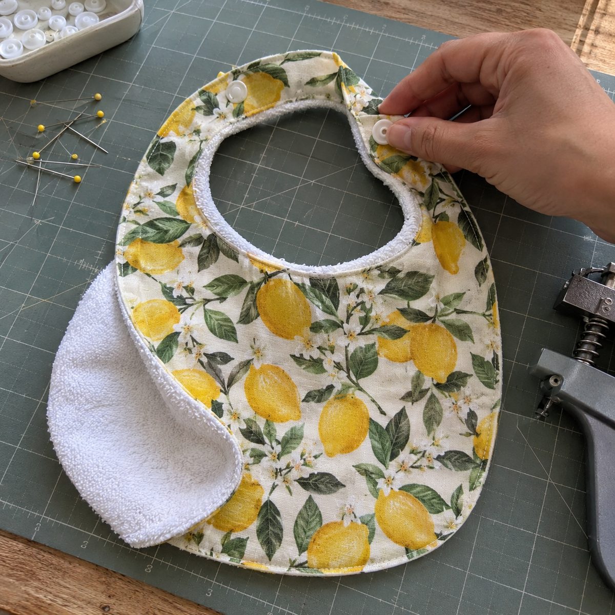 Handmade baby bib with plastic snap closure