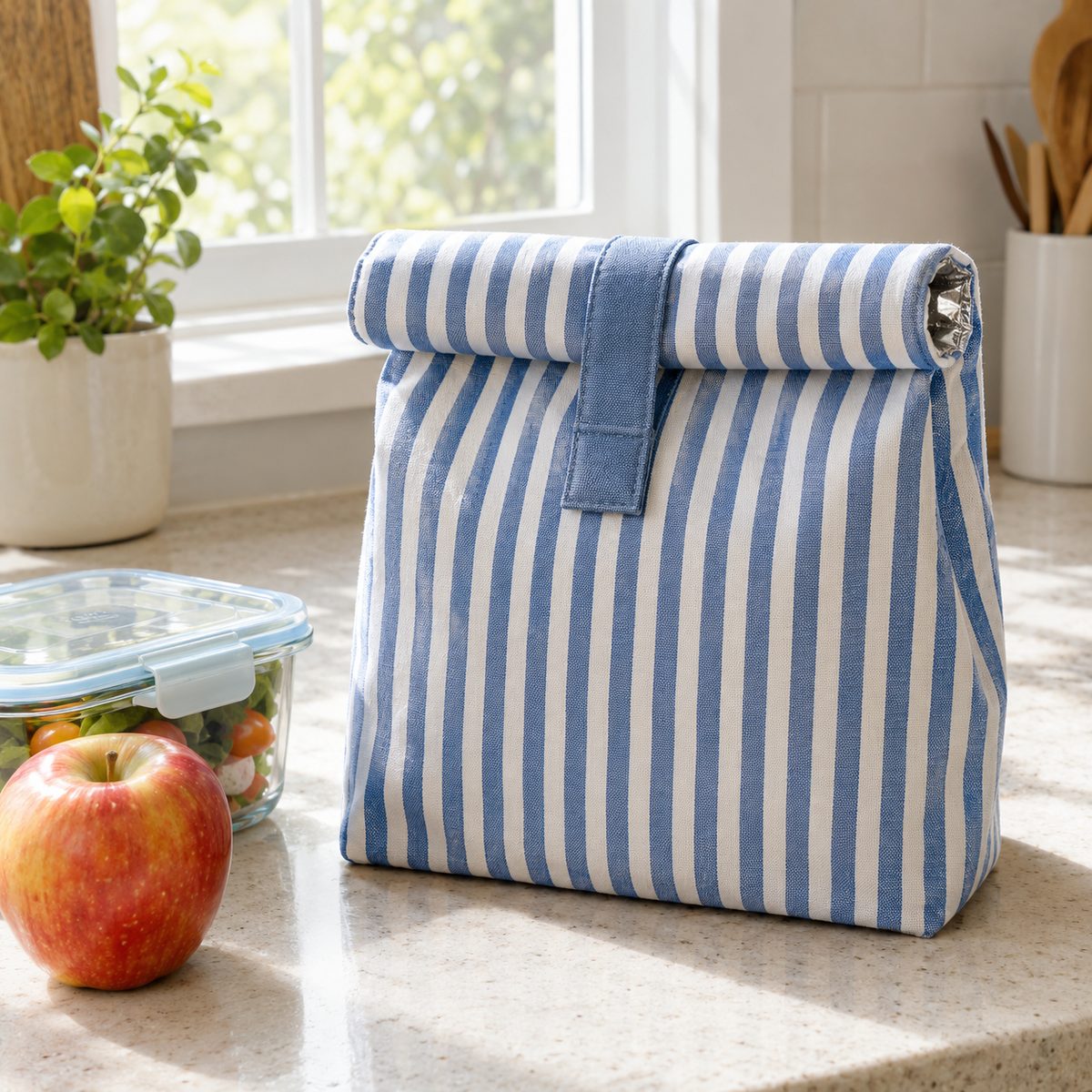 Blue striped roll-top insulated lunch bag on a kitchen counter