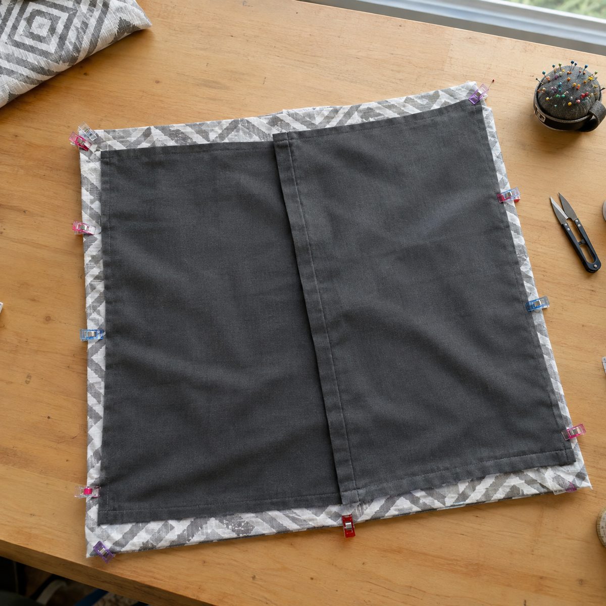 Front and back panels layered right sides together with the back panels overlapping