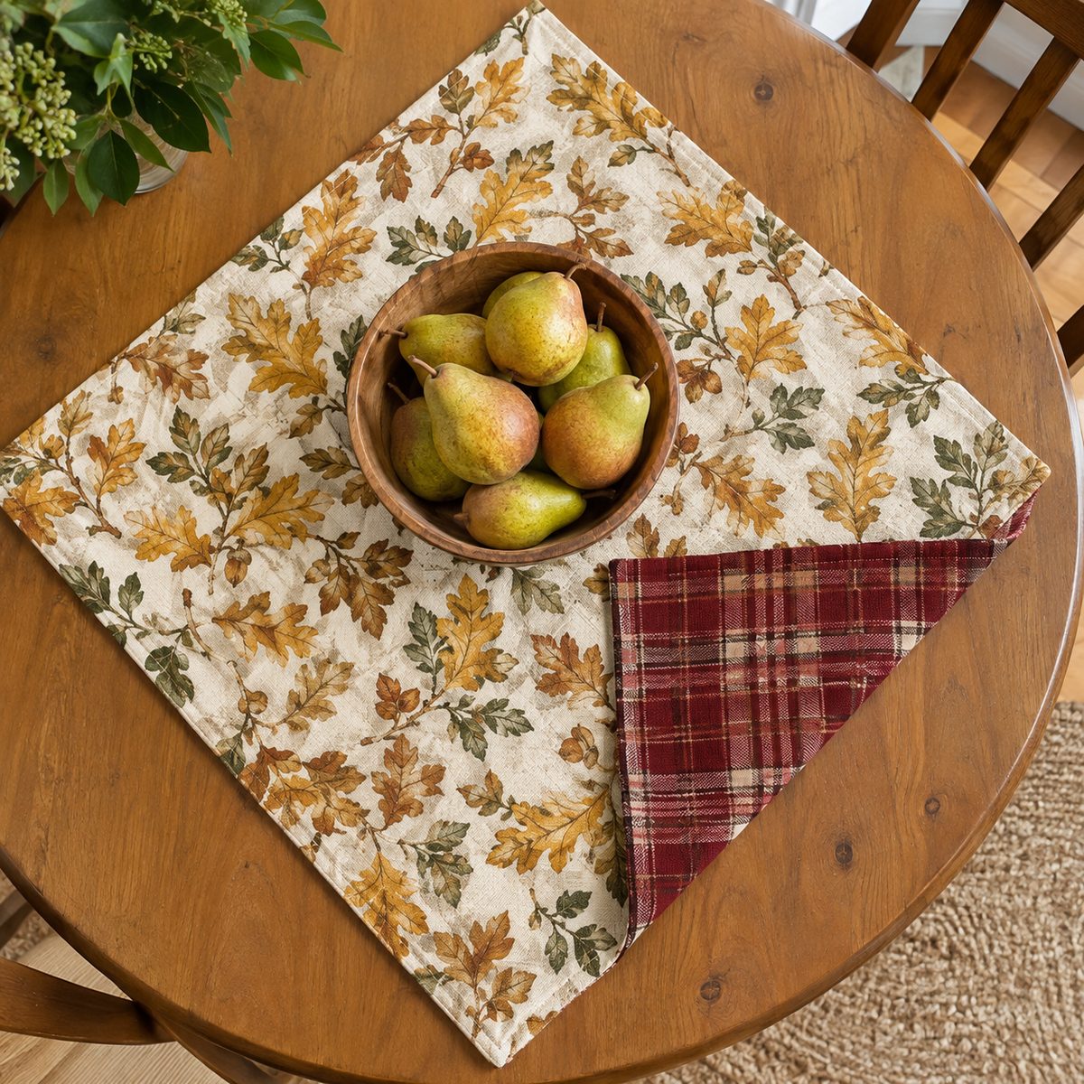 Reversible fall table topper showing leaf print and plaid sides