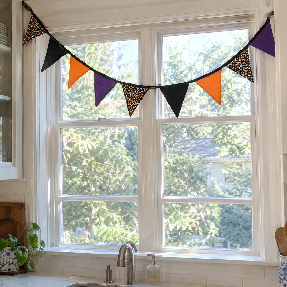 Halloween fabric pennant bunting hanging across a kitchen window
