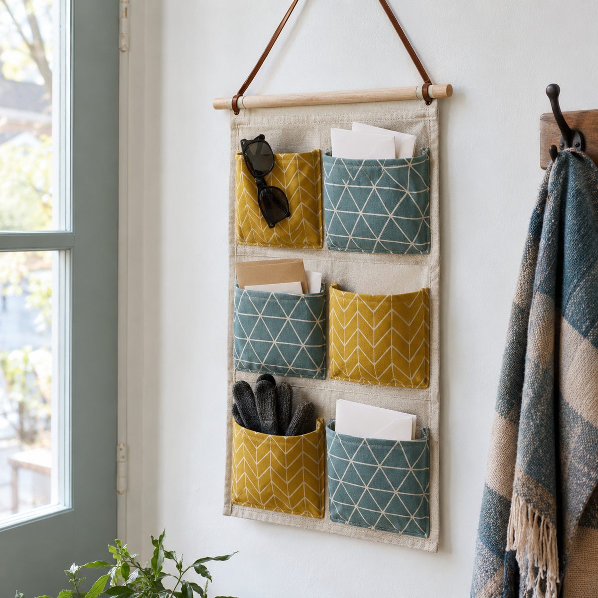 Canvas wall organizer with patterned pockets hanging in an entryway