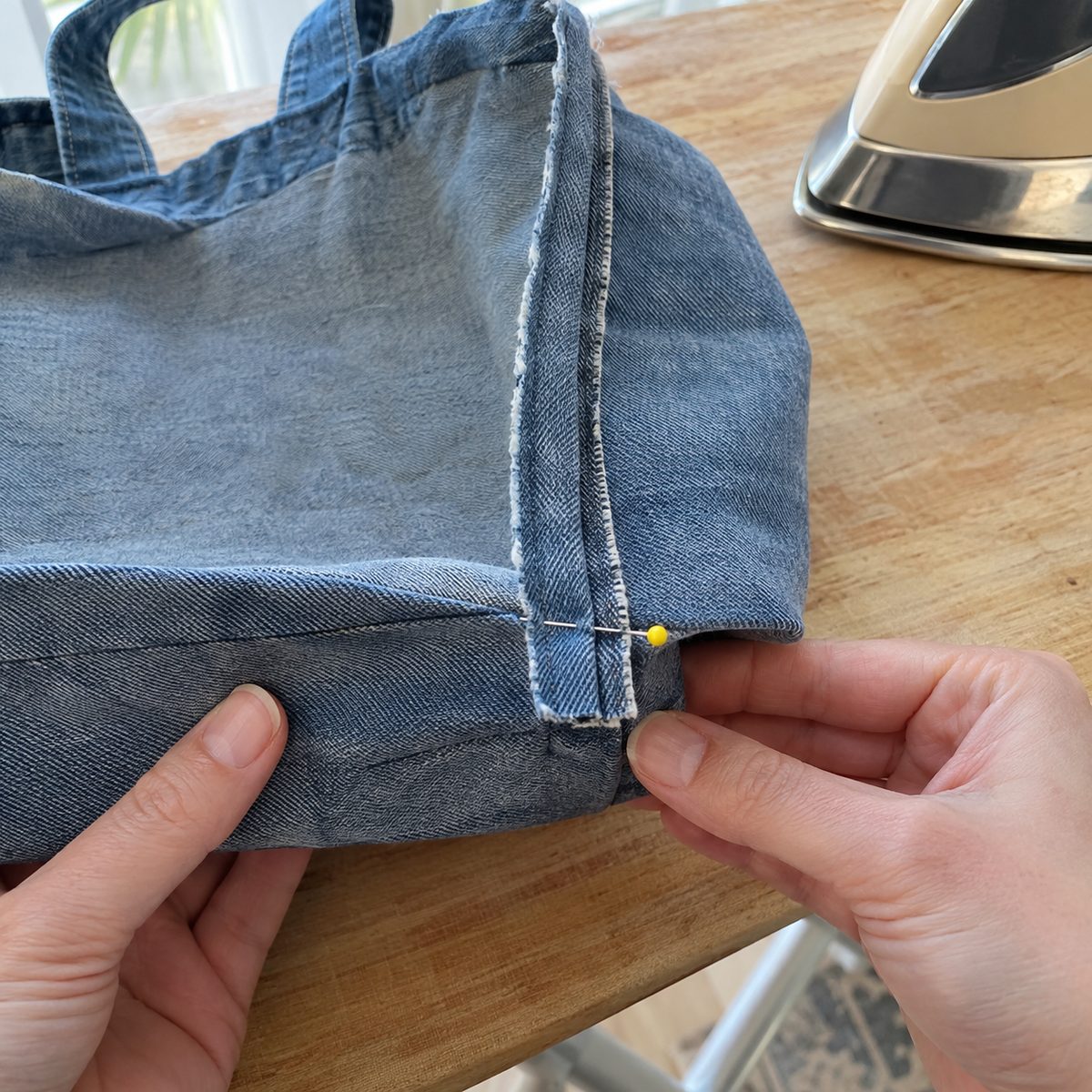 Pinching a cut-out corner so the side and bottom seams line up before boxing