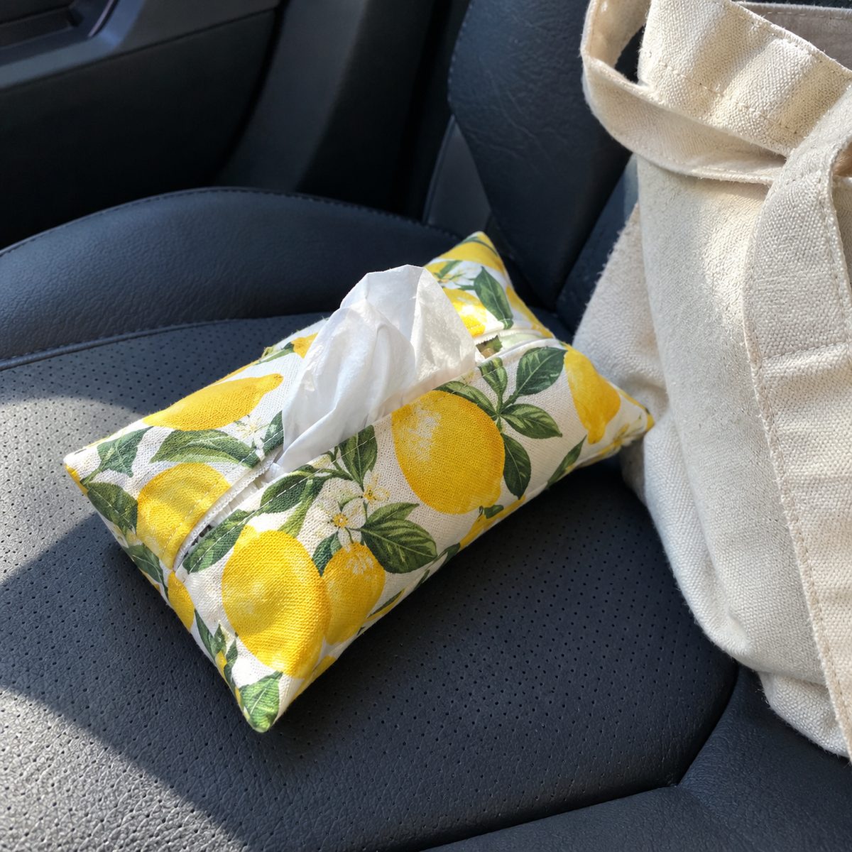 Lemon print pocket tissue holder with tissue peeking out