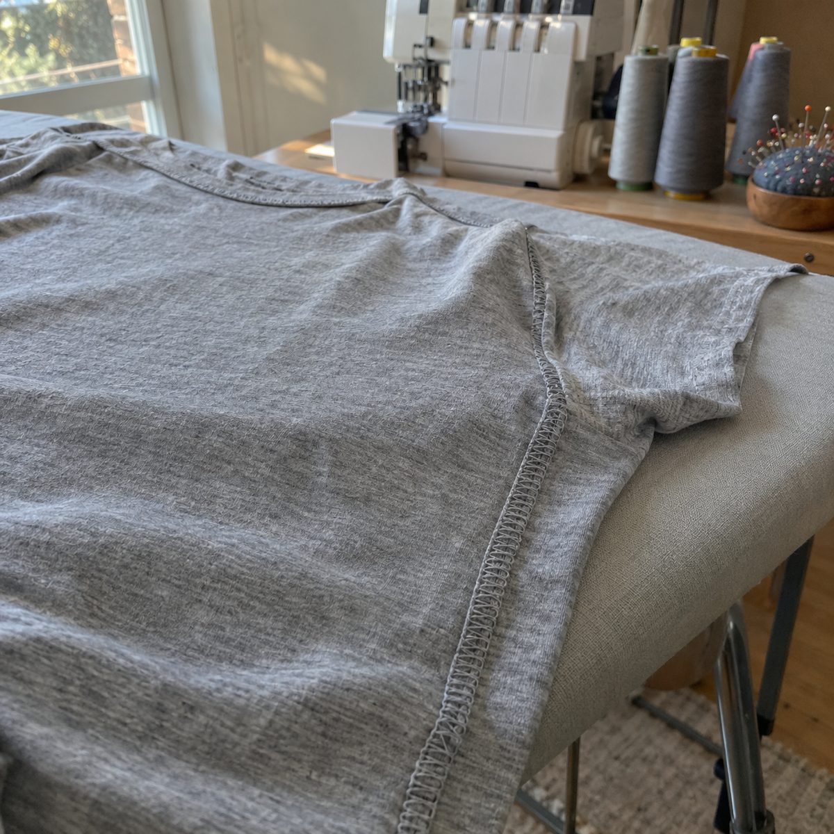 Inside of a knit t-shirt showing a neatly serged four-thread overlock seam