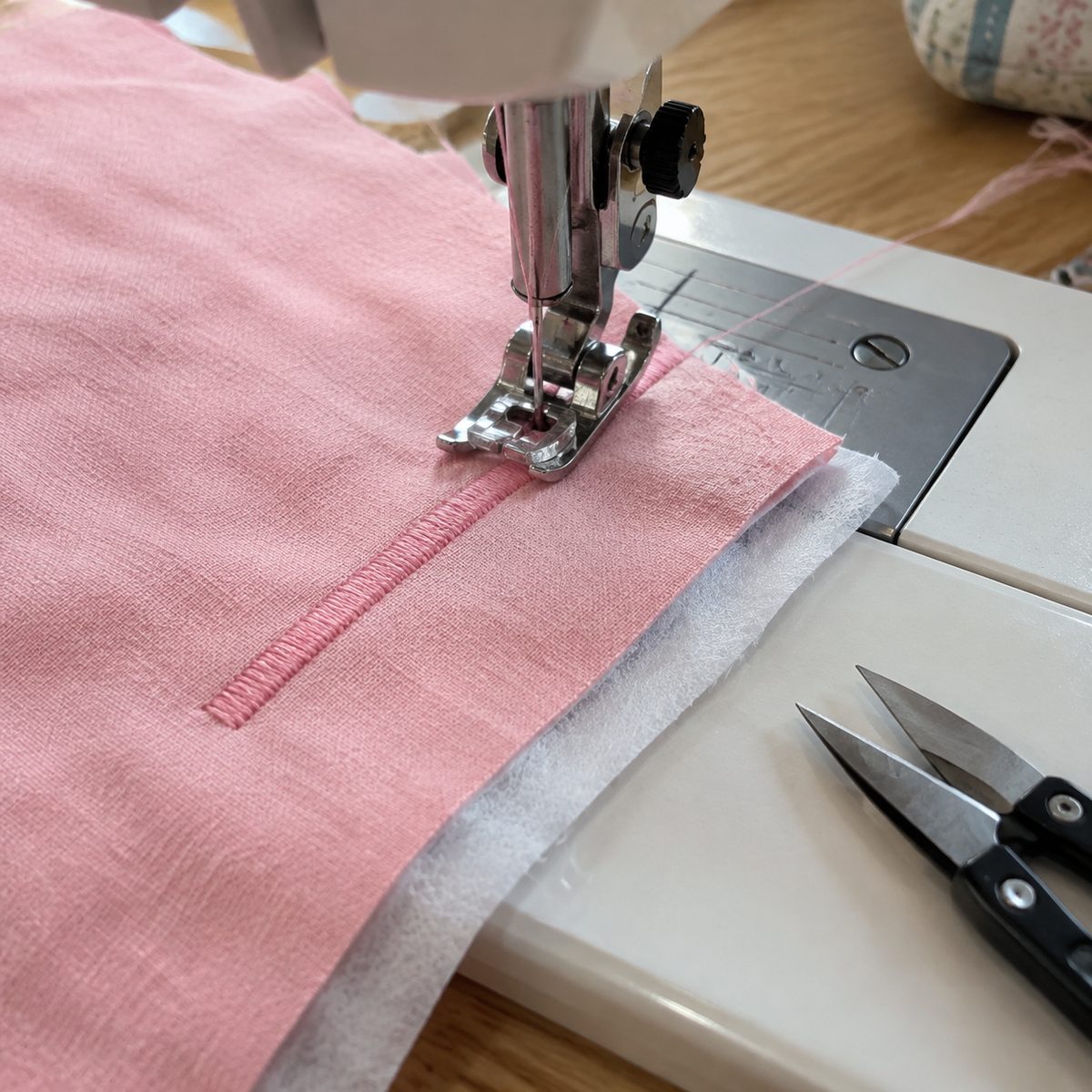 Satin stitch sewn over tear-away stabilizer on cotton fabric