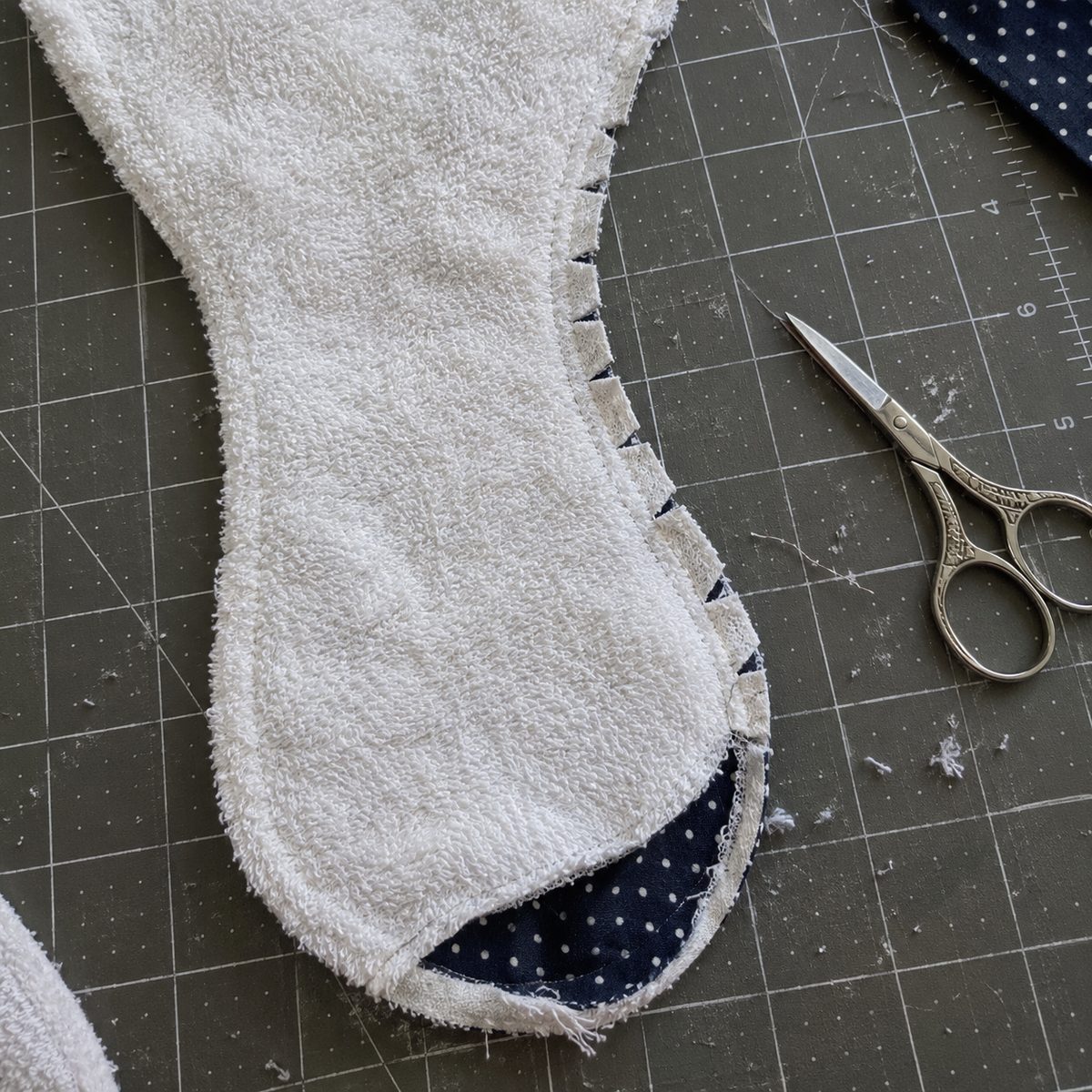 Close-up of clipped seam allowance along the curved waist of an inside-out burp cloth before turning